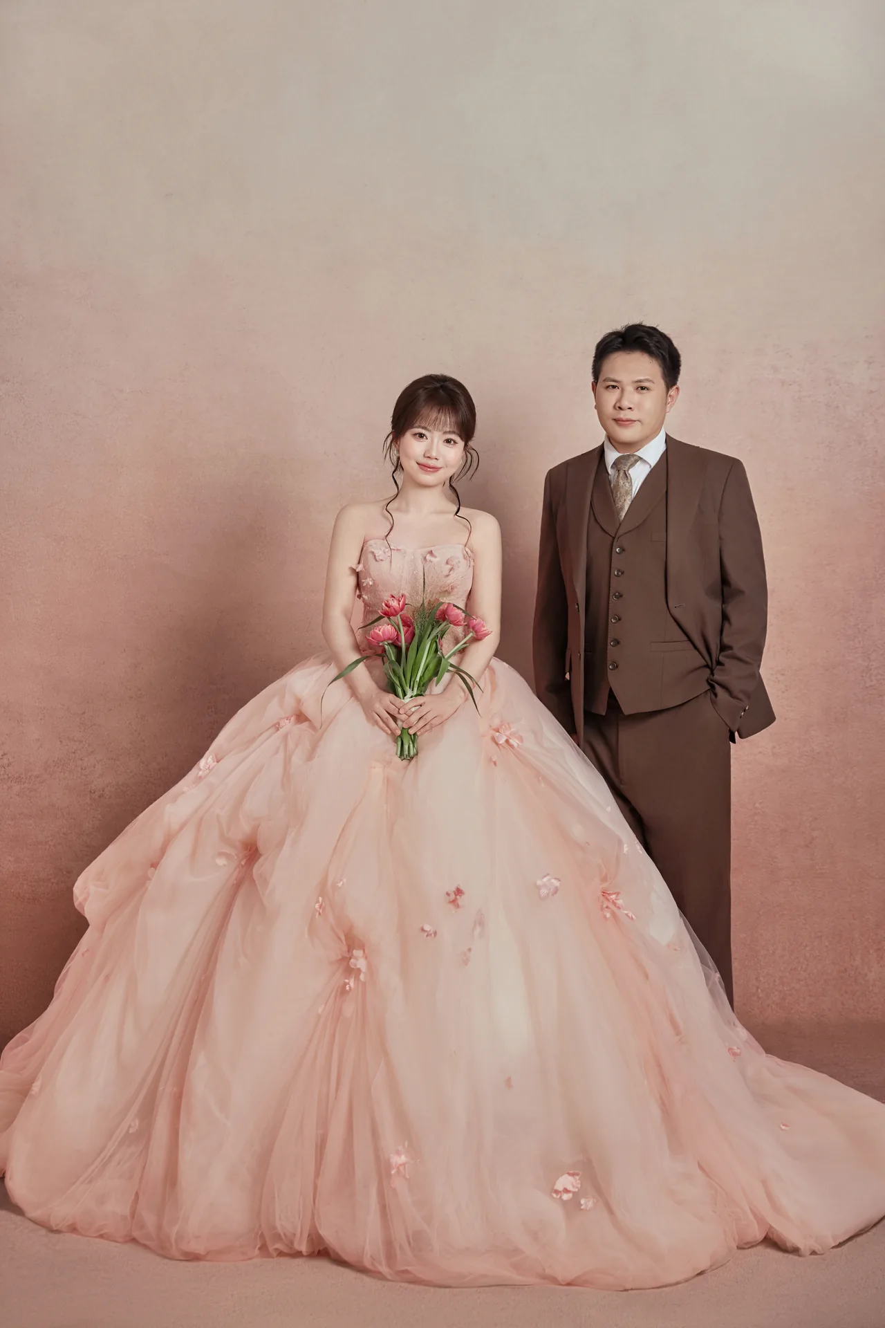 Bride and groom in soft pink editorial portrait