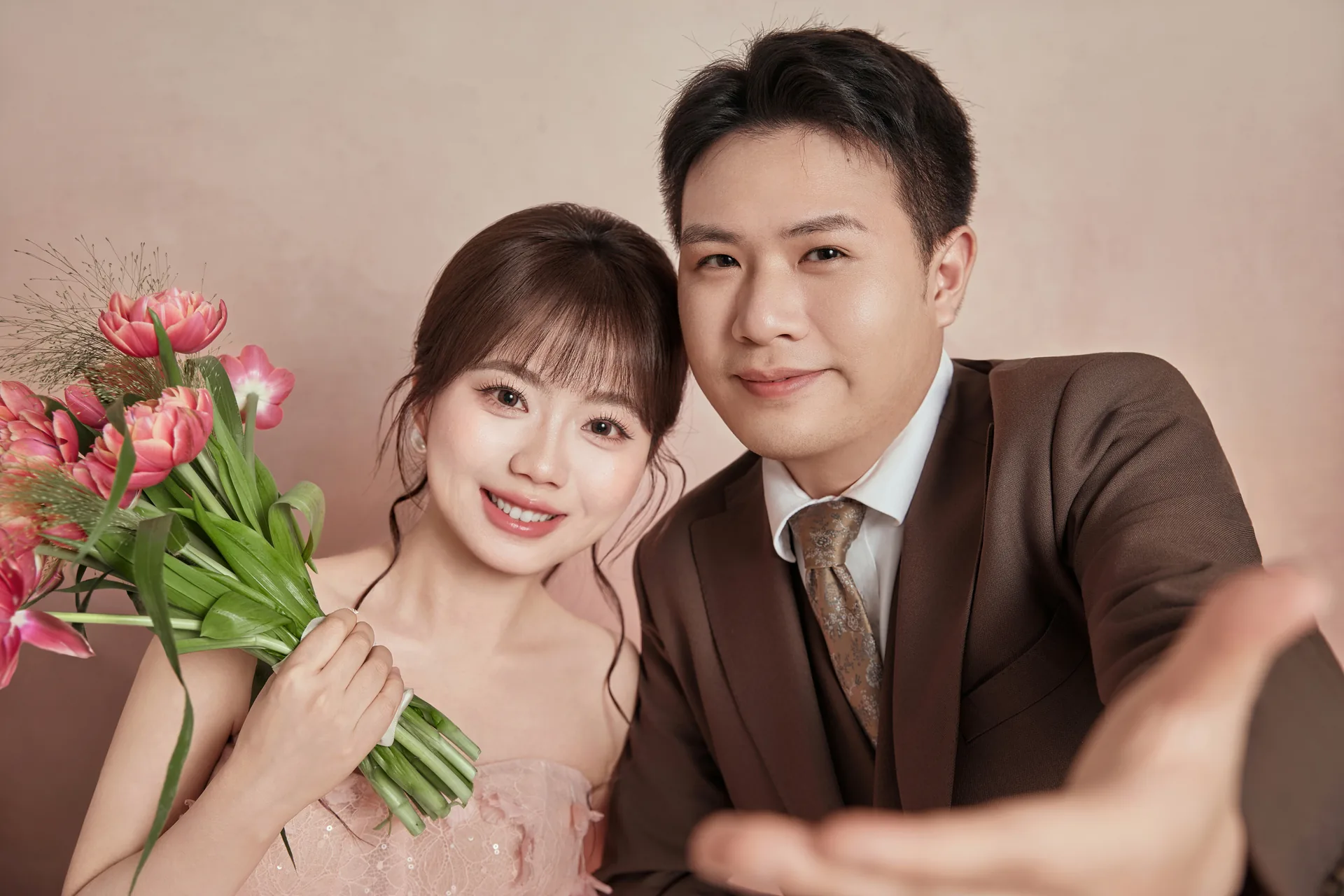 Bride in pink gown holding tulips